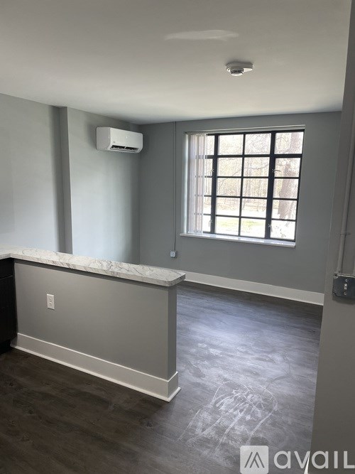 A room with a window and a marble counter.