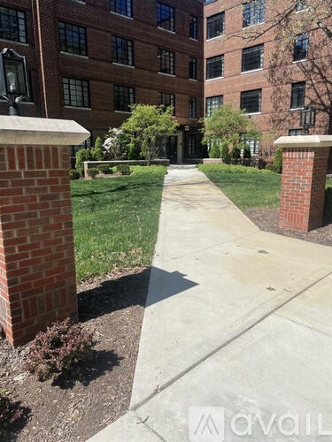 A brick building with a walkway in front.