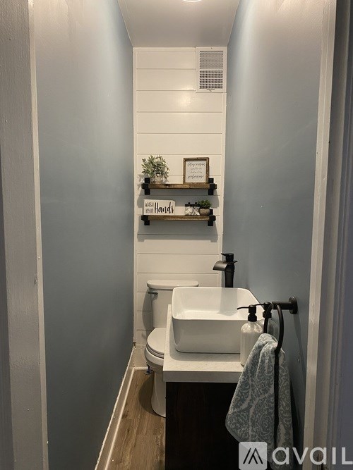 A bathroom with a white sink and toilet.