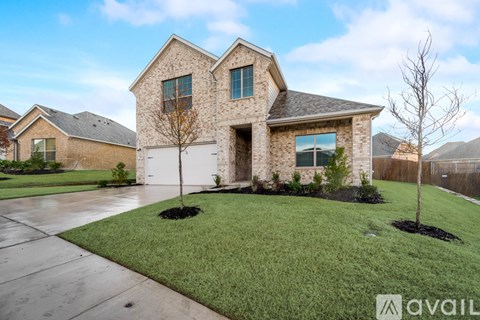 A house with a garage and a driveway in front.