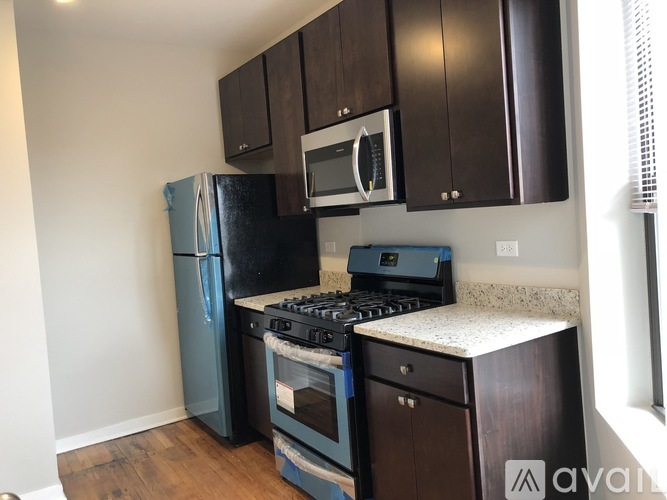 A kitchen with a black fridge, black stove, and black microwave.
