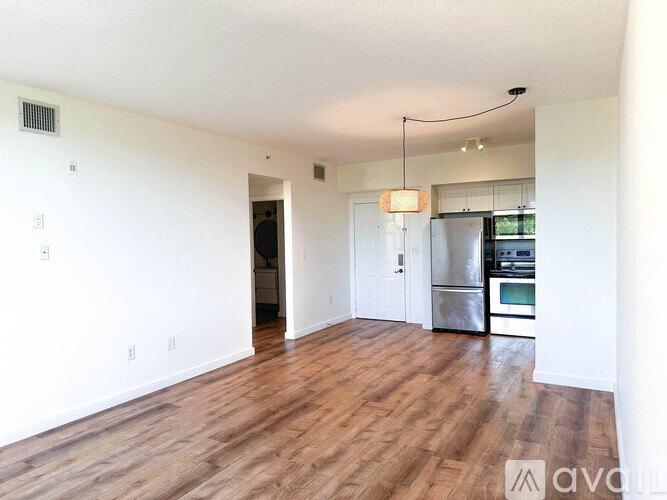 A kitchen with white cabinets and a black countertop.