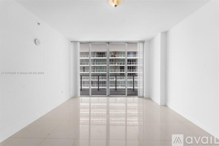 A white room with a large window and a tiled floor.