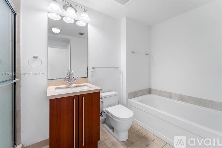 A white bathroom with a sink, toilet, and bathtub.