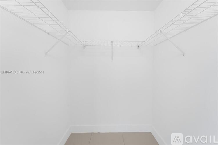 Empty room with white walls and a white ceiling.