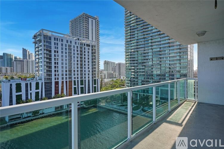 A balcony overlooks a body of water with buildings in the background.