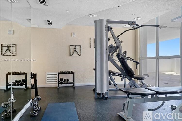 A gym with a variety of equipment including a leg press machine.