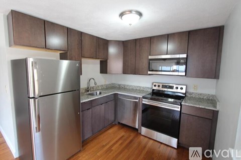 A kitchen with a stainless steel refrigerator and oven.