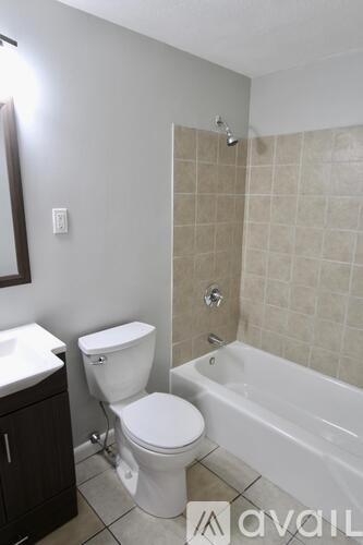 A bathroom with a toilet, sink, and bathtub.