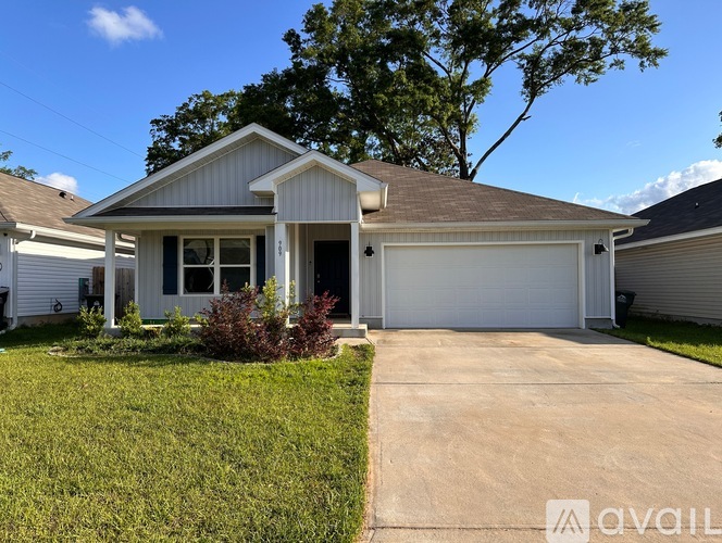 A house with a garage and a driveway is for sale.