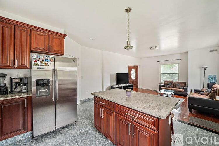 A kitchen with wooden cabinets and a granite countertop.