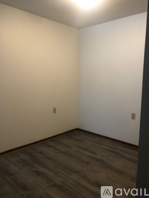 A room with a wooden floor and white walls.