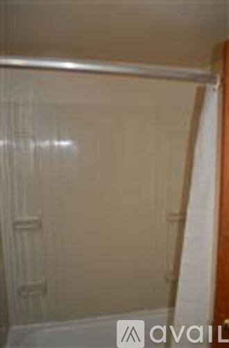 A room with a white wall and a door.