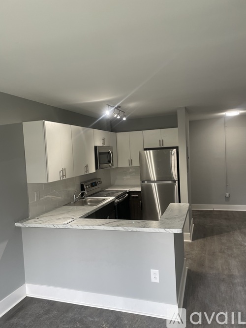 A kitchen with white cabinets and stainless steel appliances.