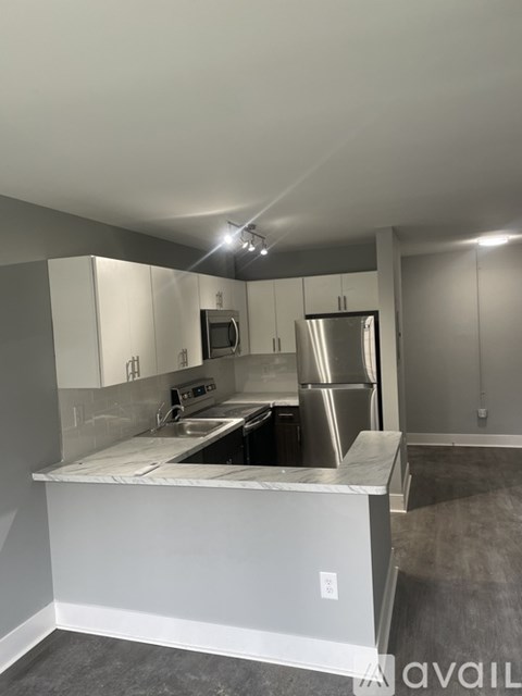 A kitchen with white cabinets and stainless steel appliances.