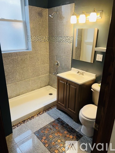 A bathroom with a toilet, sink, and bathtub.