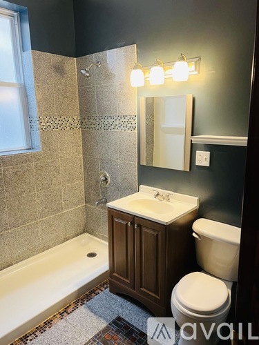 A bathroom with a white sink, toilet, and a bathtub.