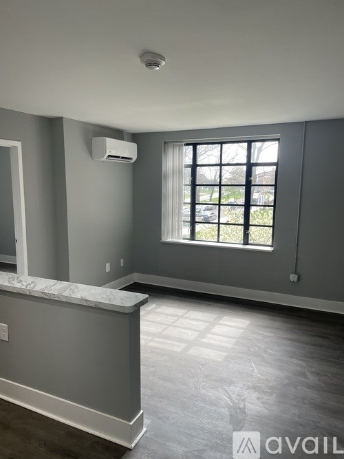 A room with a window and a marble counter.
