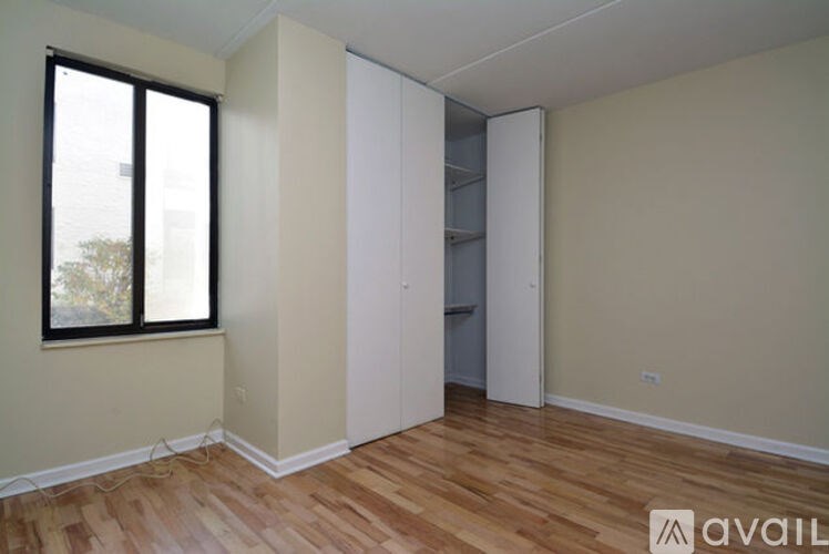 A room with a window and a white door.
