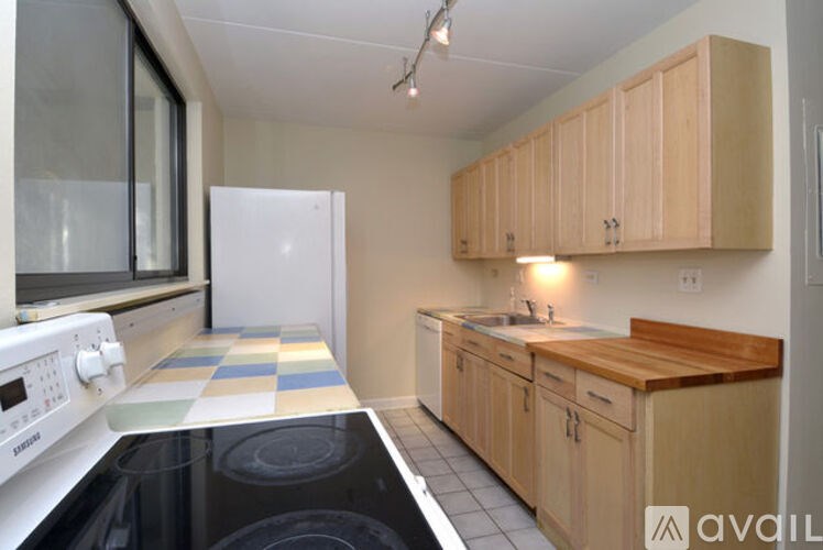 A kitchen with wooden cabinets and a white oven.