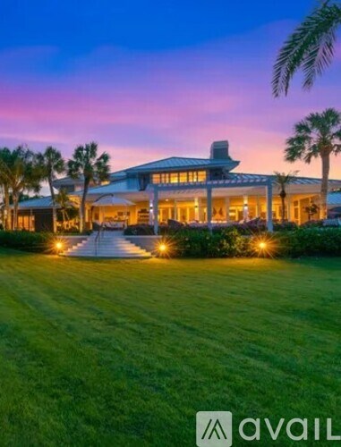A large house with a lawn in front of it.