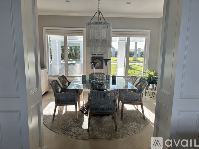A dining room with a glass table and chairs.