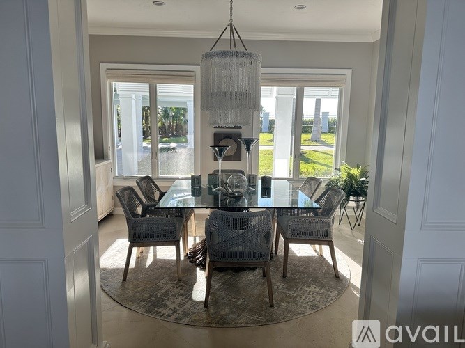 A dining room with a glass table and chairs.