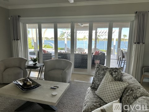 A living room with a couch, chairs, and a table with a tray on it.