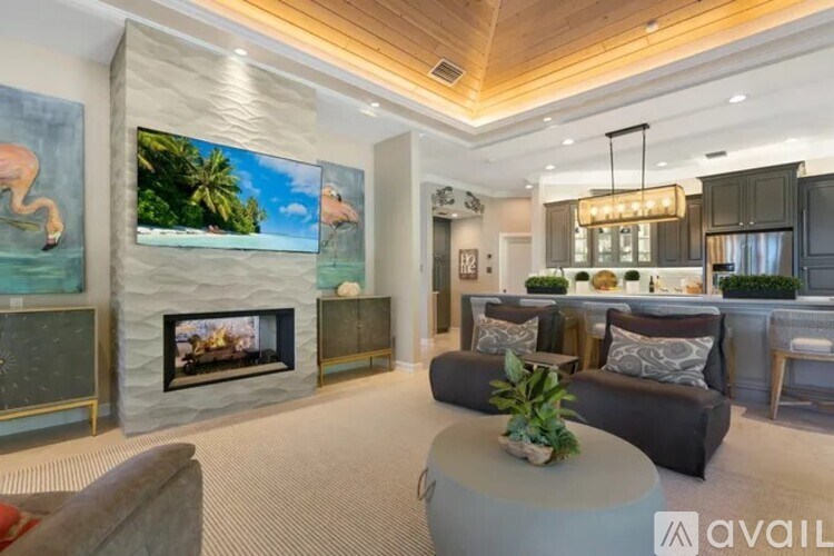 A modern living room with a fireplace and a flat screen TV.