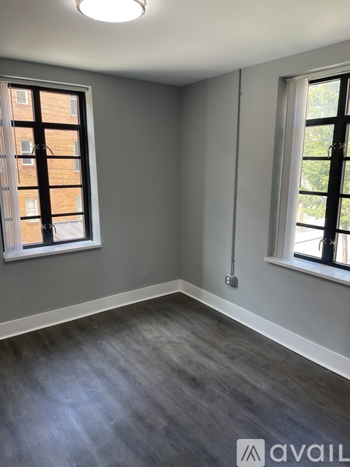A room with grey walls and a wooden floor.