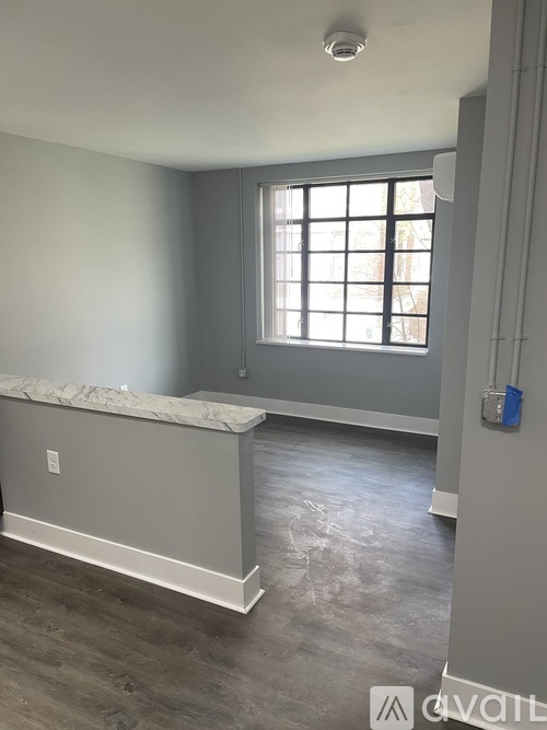 A room with a window and a marble ledge.