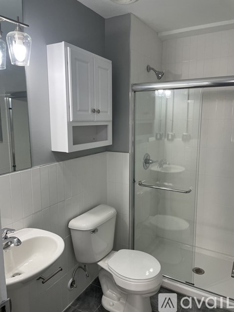 A white toilet sits next to a sink in a bathroom.