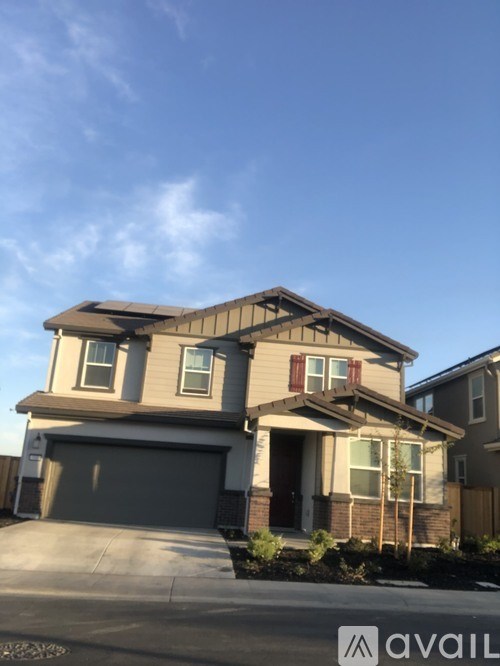 A two-story house with a garage is shown in the image.