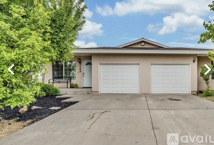 A house with a white garage door is for sale.