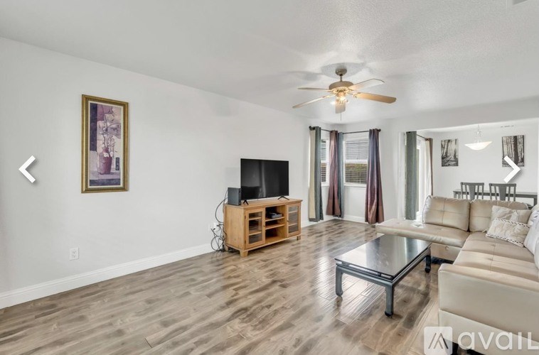 A living room with a television and a couch.