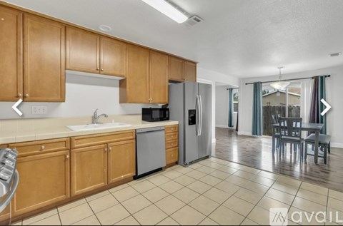 A kitchen with wooden cabinets and a refrigerator.