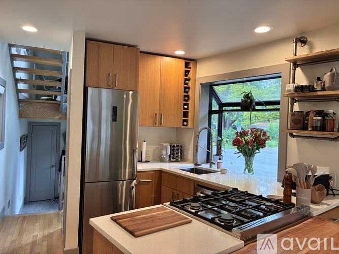 A kitchen with a stove top oven and a refrigerator.