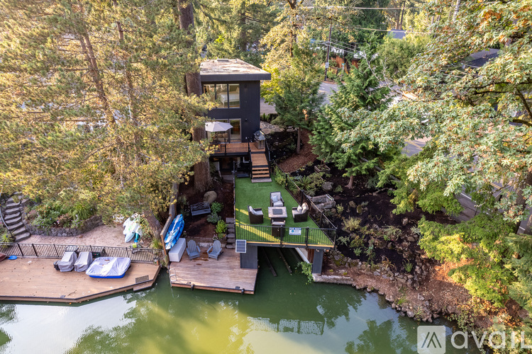 A tree-top house with a deck and a hot tub.