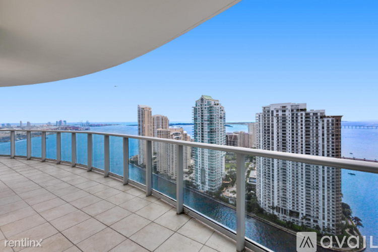A balcony with a view of a city skyline.