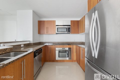 A kitchen with wooden cabinets and stainless steel appliances.
