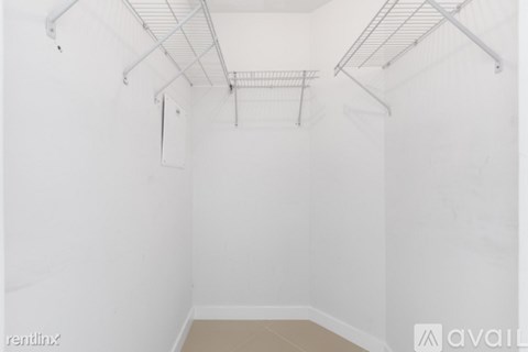 A white room with a metal rack on the ceiling.