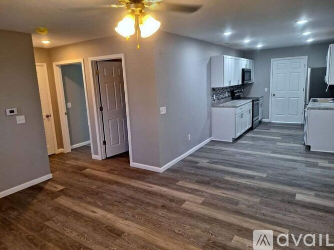 A room with a kitchenette and a dining area.