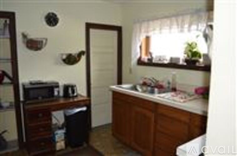 A small room with a sink and a window.