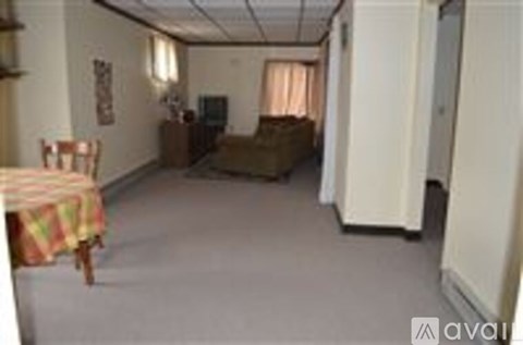 A living room with a couch, chair, and television.