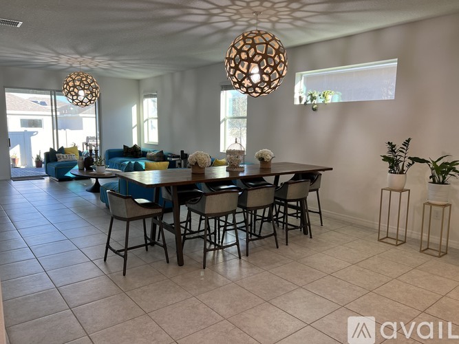 A dining room with a table set for six people.