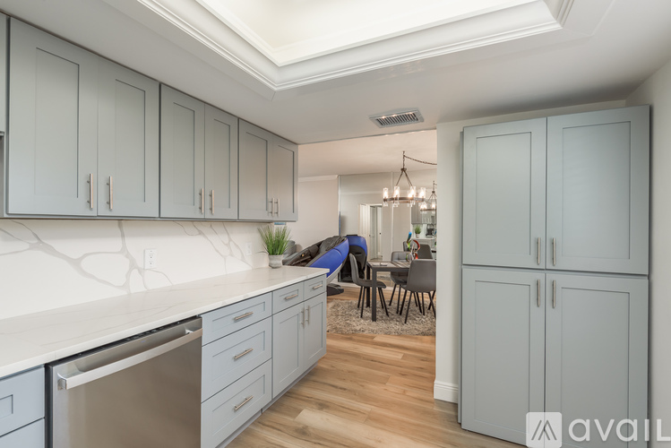 A kitchen with a dining area and a skylight.