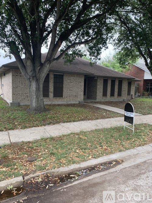 A house with a tree in front of it.