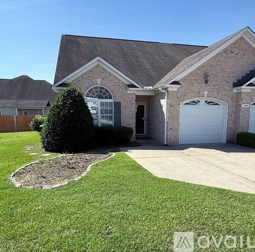 A house with a brick facade and a white garage door.