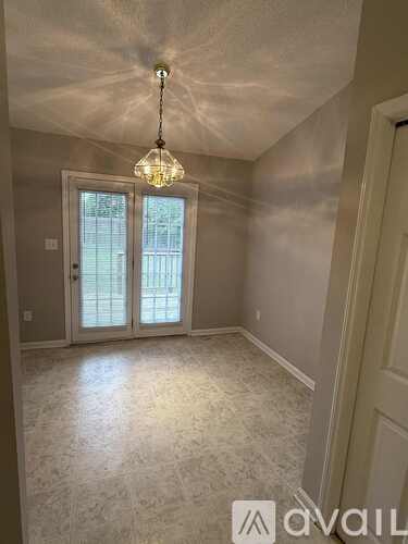 A kitchen with white cabinets and a granite counter top.