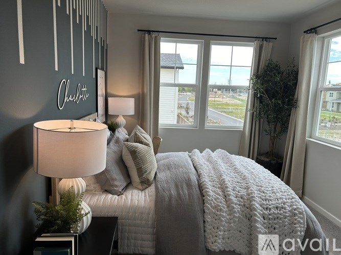 A bedroom with a large bed and a view of the outside.